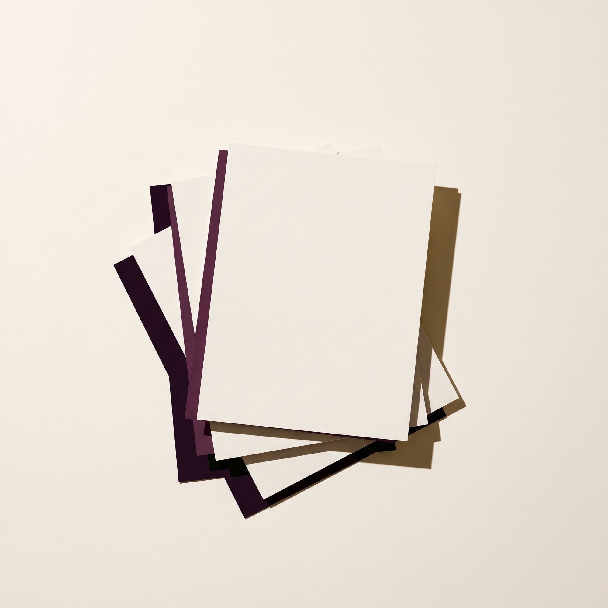 Four blank sheets of paper stacked in an offset fan.